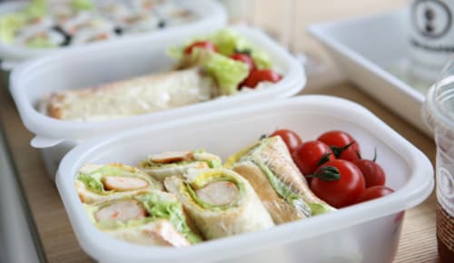 packed lunch with sandwiches and radishes